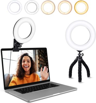 Photo showing a ring light attached to a laptop, standing alone on a desktop, and displaying a variety of light colors